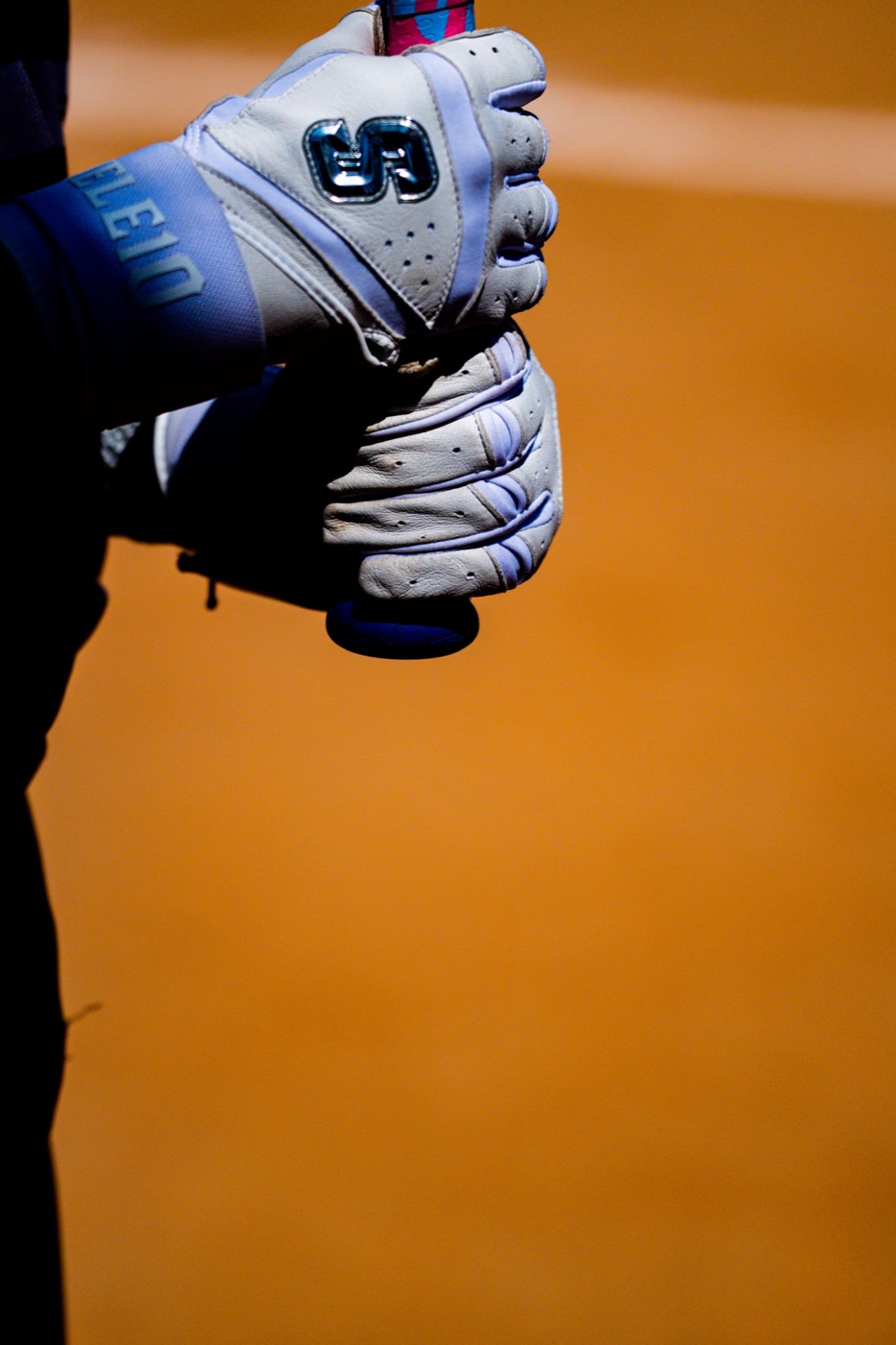 Player preparing at the plate wearing Skele10 batting gloves